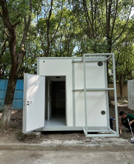 Field-installed modular cleanroom exterior with personnel door and service penetrations for pressure cascade planning