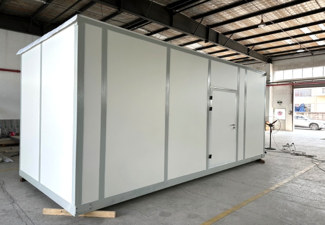 Container laboratory cleanroom interior with white wall panels cleanroom door return air grille and utility outlets